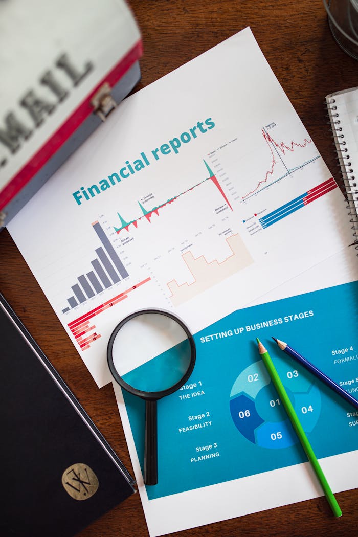 about-02 Financial report with charts and graphs analyzed with a magnifying glass.